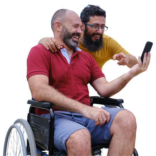 A man in a wheelchair talks on speakerphone with a DIAL advisor, while his friend supports him.