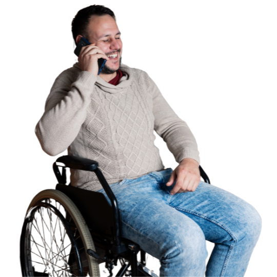 Man in a wheelchair smiles as he talks to our PAMAS team on the phone.