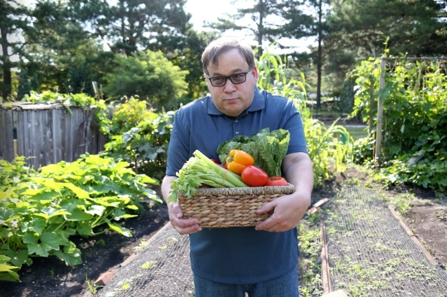 A man at a community allotment, representing support tailored to each person's life.